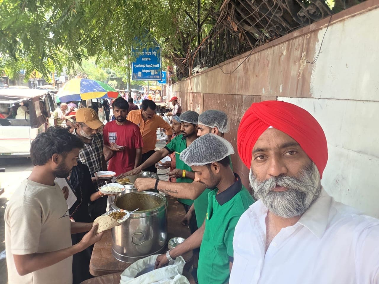 Meals being handed to underprivileged community members at an Al Ranim Properties hunger relief programme in India