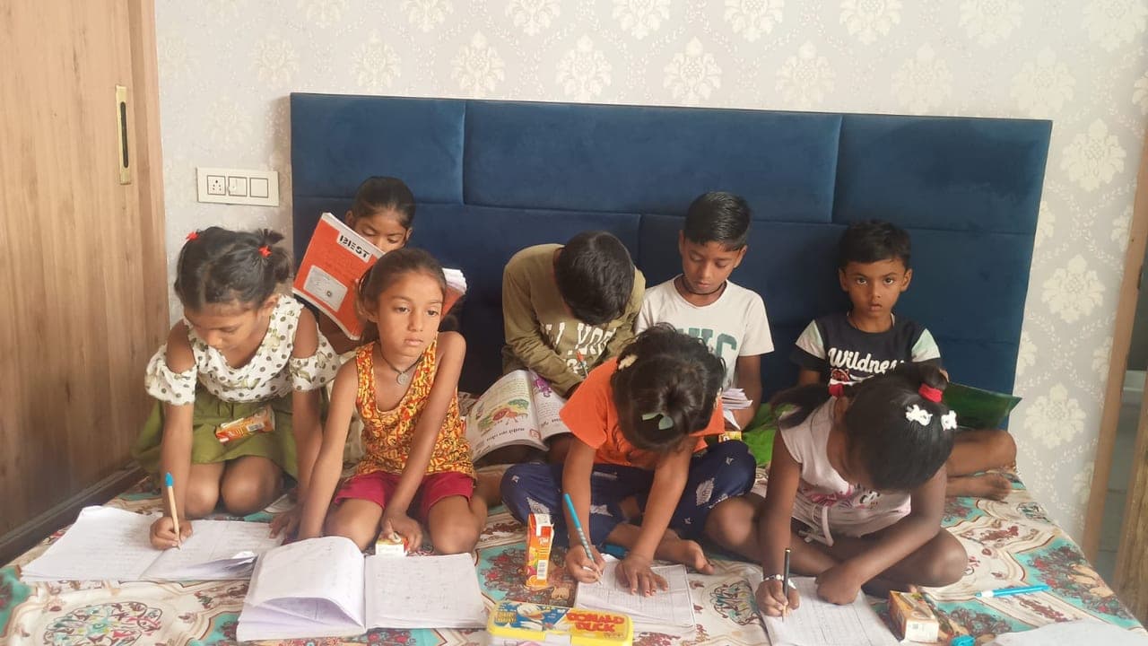 Sponsored children studying and doing their schoolwork at an Al Ranim Properties-supported programme in India