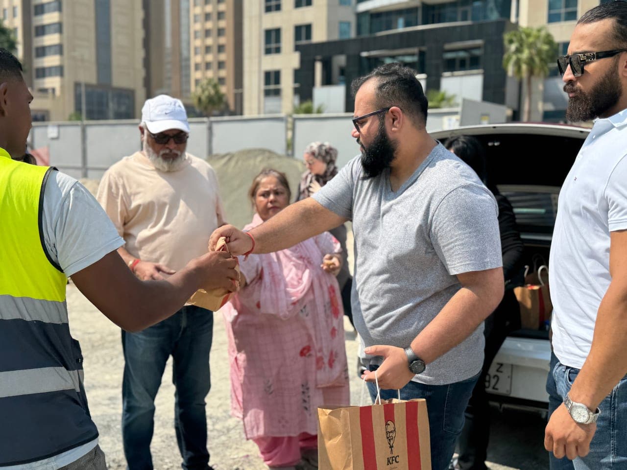 Packed meals being distributed to workers on site in Dubai by the Al Ranim Cares team