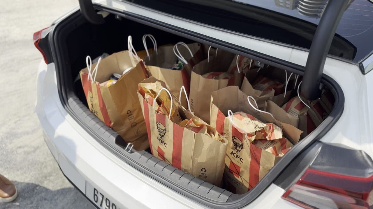 Car boot filled with packed meal bags ready for distribution to construction workers in Dubai