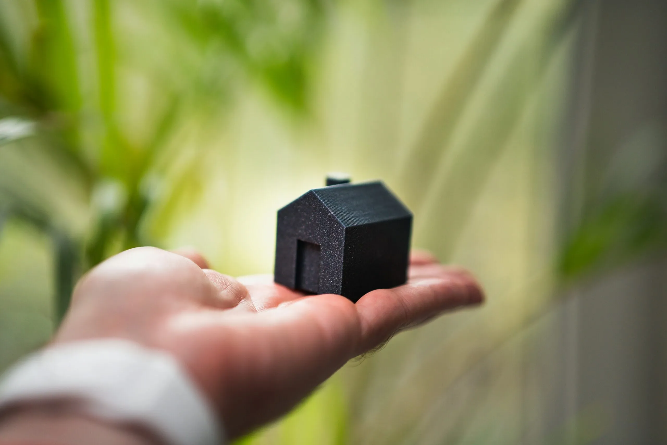 Hand holding a model house, symbolising the future of Dubai real estate careers